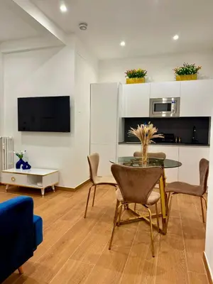 a living room with a glass table and chairs at Sweet Life Monteverde in Rome