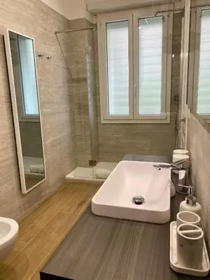 a bathroom with a tub and a shower and a sink at Sweet Life Monteverde in Rome