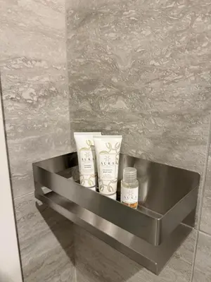 a shelf in a bathroom with someorative products on it at Sweet Life Monteverde in Rome