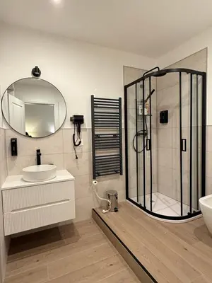 a bathroom with a shower and a sink and a mirror at Vita Lux Vatican Suites in Rome