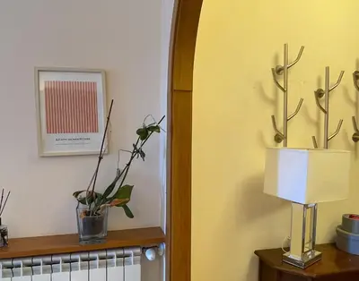 a room with a shelf with plants and a lamp at MARIA TERESA Apartment - Sophisticated Living and City Links - Quartiere TRIESTE in Rome