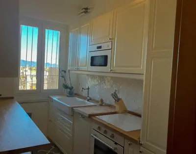 a white kitchen with a sink and a microwave at MARIA TERESA Apartment - Sophisticated Living and City Links - Quartiere TRIESTE in Rome