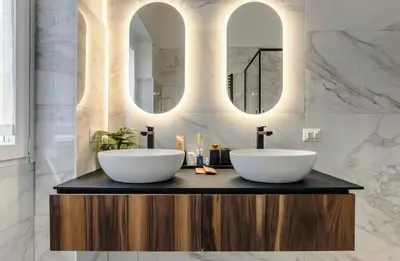 a white room with a bed and a mirror at San Lorenzo Home in Rome