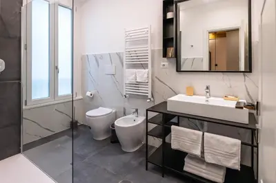a bathroom with a sink and a toilet and a mirror at EFFE 9 FLAMINIO Guest House in Rome-Vatican City in Rome