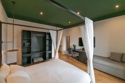a bedroom with a white bed and a desk at EFFE 9 FLAMINIO Guest House in Rome-Vatican City in Rome
