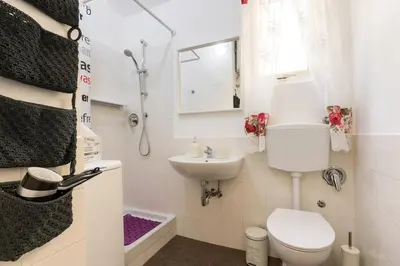 a small bathroom with a toilet and a sink at Roma MetroB Apartment in Rome