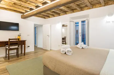 a bedroom with a bed and a desk and a computer at Boutique Atrium Pantheon in Rome