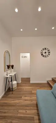 a room with a bed and a clock on the wall at Rooms And Comfort Apartment in Rome