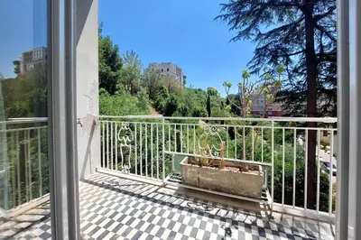 a balcony with a plant in a pot on a railing at Vatican Rooms Mura Aurelie in Rome