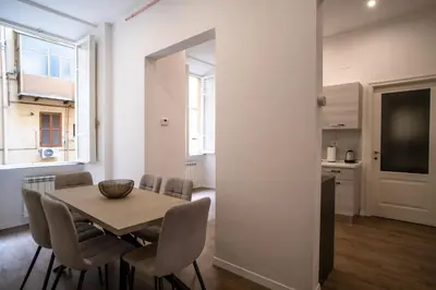 a dining room with a table and chairs at VT Cola di Rienzo Elegant Suites in Rome