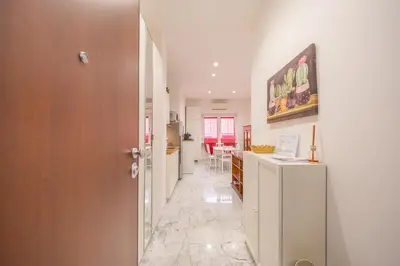 a hallway leading to a kitchen and a living room at vaticanloft for you in Rome