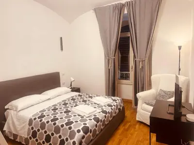 a bedroom with a desk and a bed and a lamp at B&B Lorenzo 7HillsRoma in Rome