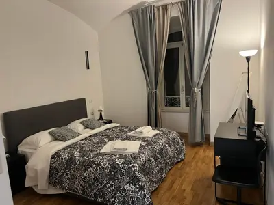 a bedroom with a bed with two towels on it at B&B Lorenzo 7HillsRoma in Rome