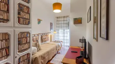 a living room with a couch and some books at casabella cipro musei vaticani in Rome