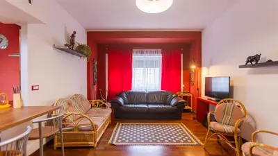 a living room with a leather couch and a television at casabella cipro musei vaticani in Rome
