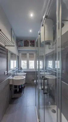 a large bathroom with three sinks and a shower at casabella cipro musei vaticani in Rome