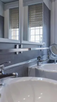 a bathroom with two sinks and a mirror at casabella cipro musei vaticani in Rome
