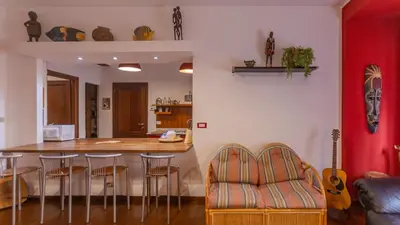 a kitchen with a counter and a bar with stools at casabella cipro musei vaticani in Rome