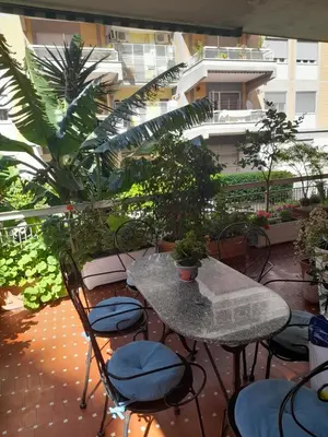 a patio with a table and chairs and plants at stella condo in Rome