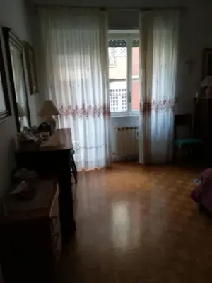 a living room with a desk and a window at stella condo in Rome