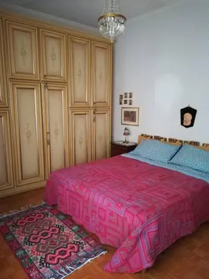 a bedroom with a large bed with a pink blanket at stella condo in Rome