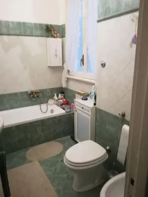 a bathroom with a toilet and a tub and a sink at stella condo in Rome