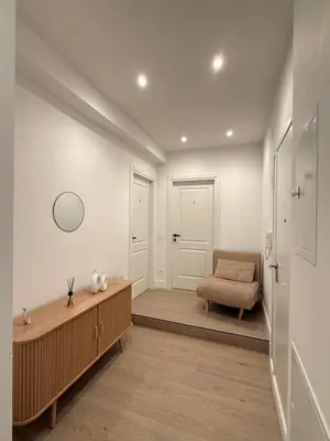 a hallway with a bench and a chair in a room at Vita Lux Vatican Suites in Rome