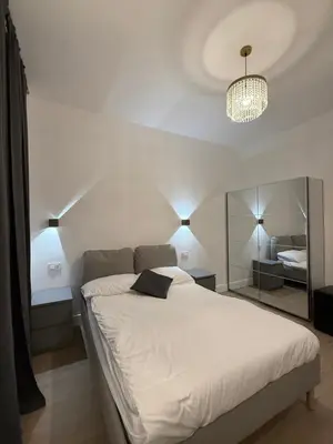 a bedroom with a large white bed with a mirror at Vita Lux Vatican Suites in Rome