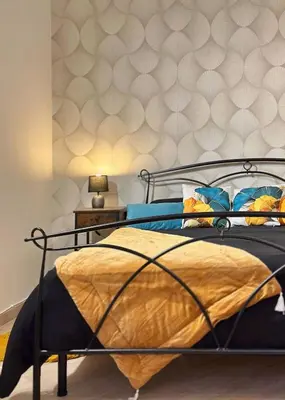 a bedroom with a bed with a gold bedspread at MaLoMA Home intero alloggio fronte metro A in Rome