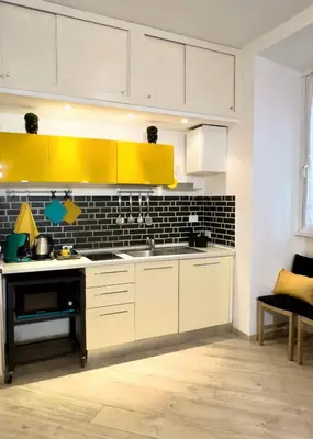 a kitchen with white cabinets and a yellow sink at MaLoMA Home intero alloggio fronte metro A in Rome