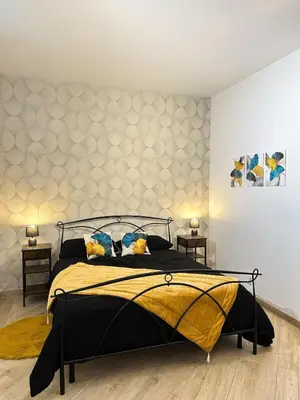 a bedroom with a large bed and two tables at MaLoMA Home intero alloggio fronte metro A in Rome