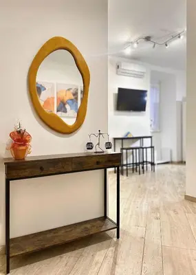 a room with a table with a mirror on the wall at MaLoMA Home intero alloggio fronte metro A in Rome