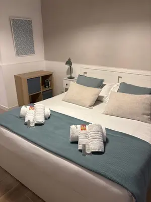 a bedroom with a bed with towels on it at The Hatters Inn in Rome