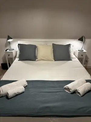 a large white bed with two towels on it at The Hatters Inn in Rome