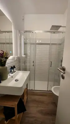 a bathroom with a white sink and a shower at The Hatters Inn in Rome