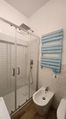 a bathroom with a shower and a toilet and a sink at The Hatters Inn in Rome