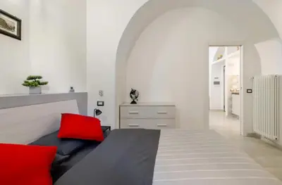 a bedroom with a large bed with red pillows at La Casetta Sabelli In the center of Rome in Rome
