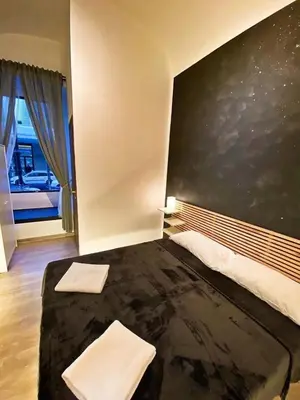 a room with a bed with a chalkboard on the wall at Cialdini 13 Roma in Rome