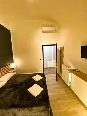 a room with a bed and a door to a hallway at Cialdini 13 Roma in Rome