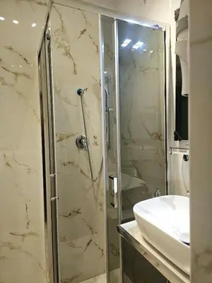 a bathroom with a glass shower and a sink at Cialdini 13 Roma in Rome
