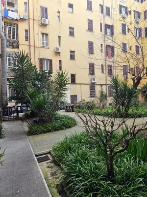 an apartment complex with a courtyard with plants and a building at Cialdini 13 Roma in Rome
