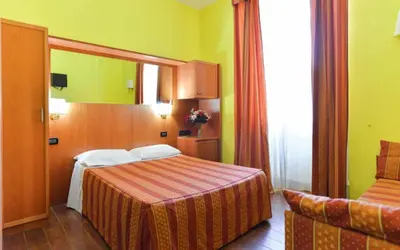 two beds in a room with red sheets at Ogbay Backpackers Haven in Rome
