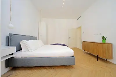 a bedroom with a bed and a dresser in it at YCH-Spaceful apartment near Vatican in Rome
