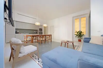 a living room with a blue couch and a table at YCH-Spaceful apartment near Vatican in Rome