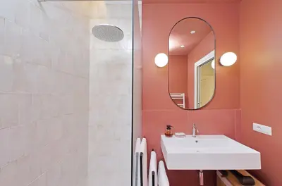 a bathroom with a white sink and a mirror at YCH-Spaceful apartment near Vatican in Rome