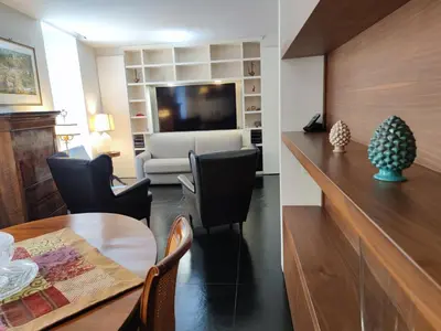 a living room with a dining table and a living room with a tv at Banchi Nuovi Ventuno in Rome