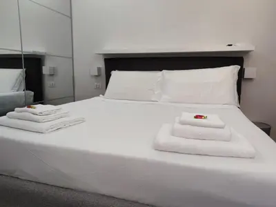 a white bed with towels on top of it at Banchi Nuovi Ventuno in Rome