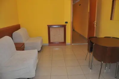 a living room with a couch and a table and chairs at Friends Holiday in Rome