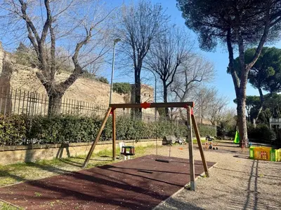 a playground in a park with a swing at Caracalla Loft in Rome