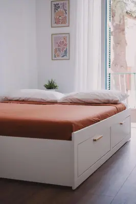 a bedroom with a bed with a white bed frame at Casetta in Rome